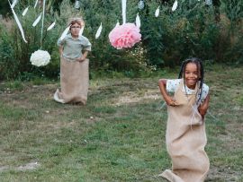 sackhüpfende Kinder mit Jute Sack